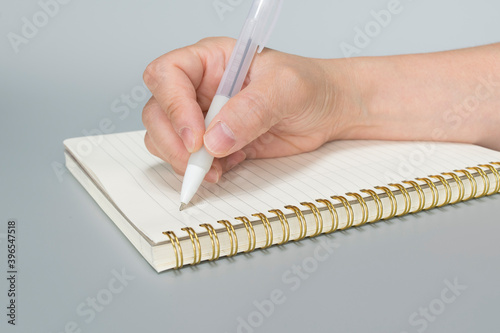 Working woman's hand. Female hand writing a note