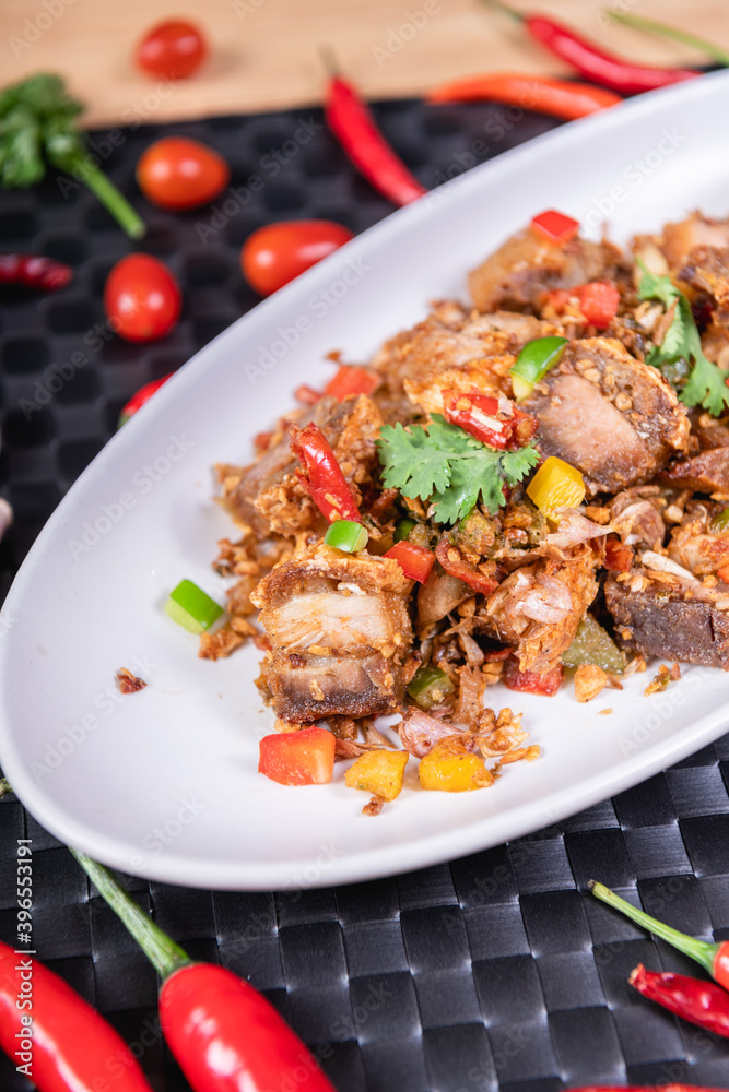 Fried Crispy Pork On a white plate- Thai food style
Fried Crispy Pork On a white plate- Thai food style