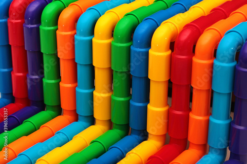 Rainbow colored plastic pipes as background