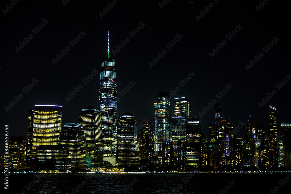 New York City Manhattan skyline panorama at night over Hudson river with reflections viewed from New Jersey