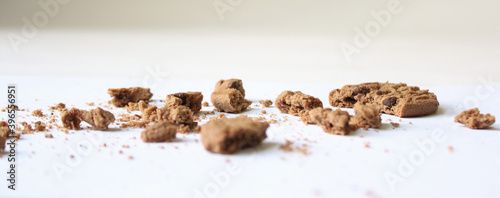 Fotografie Chocolate chip cookies with crumbs isolated on white background