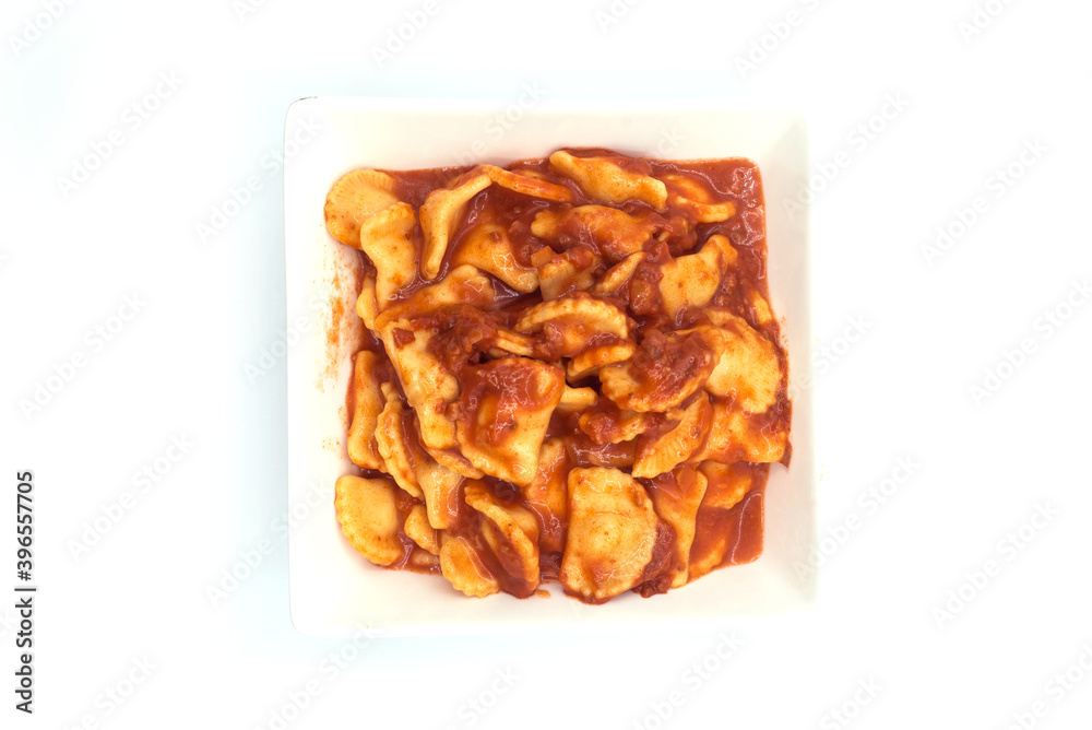 Top view of industrial raviolis in a white plate on white background Top view of industrial raviolis in a white plate on white background