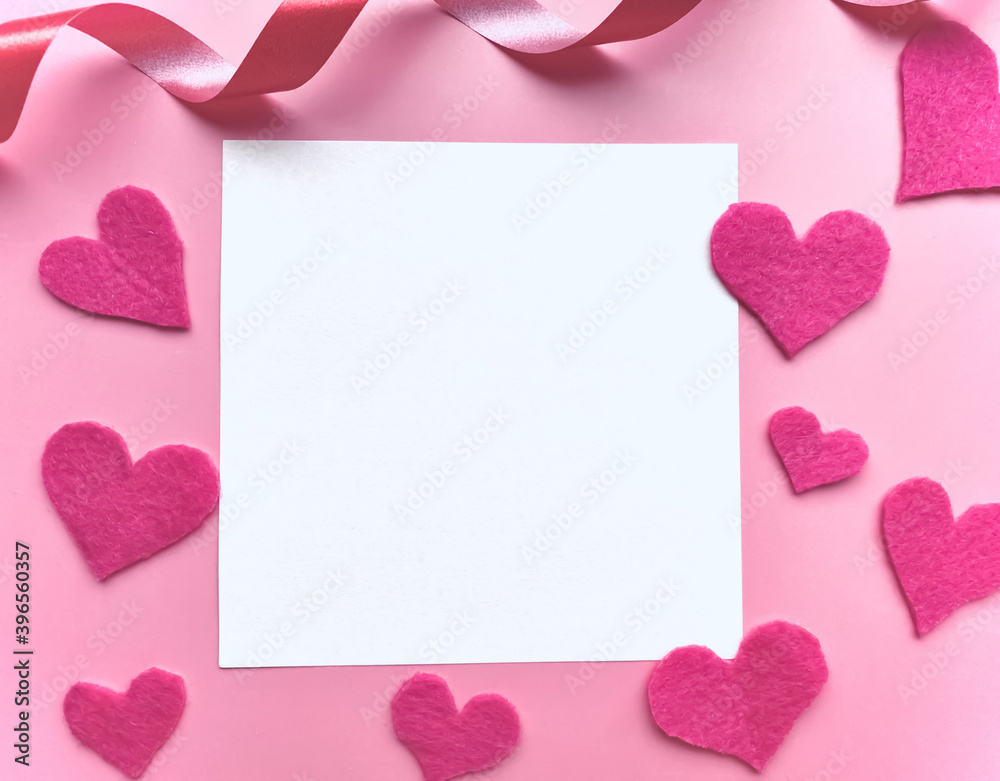 Valentine's day background.  Frame from pink hearts on a pink background and white blank card.  Love concept.  Flat lay, copy space.  Card .