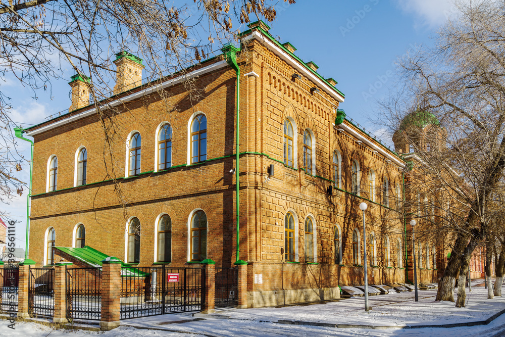 Orenburg, Russia - September, 14, 2020: Corner of an old brick building with a dome of the house church. Gymnasium number 2 on Brykina street
