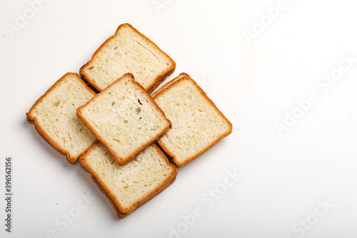 Cut of loaf bread on white against white background