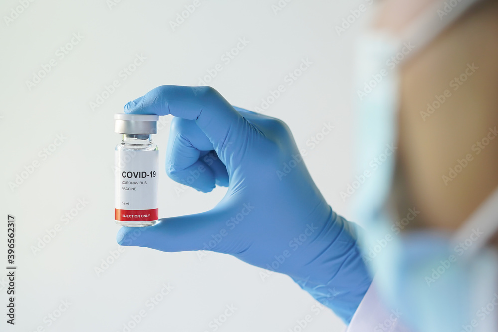 close up hands of doctor holding vaccine of covid-19 disease or corona virus.