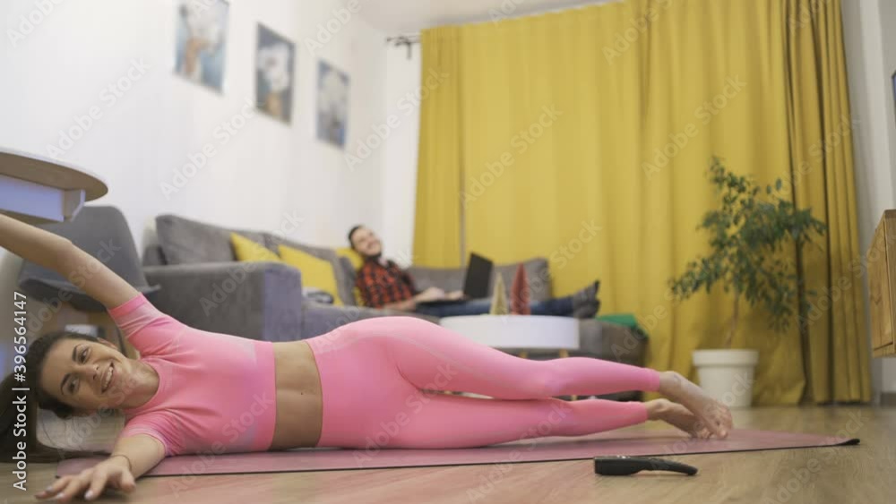 Sporty flexible woman doing stretching exercises at home Sporty flexible woman doing stretching exercises at home