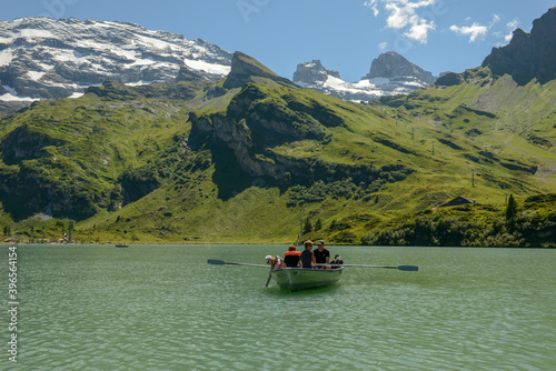 Tourists rowing in their boat at lake Truebsee above Engelberg on the Swiss Alps