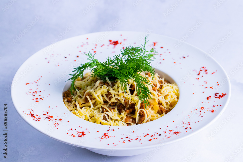 Delicious bolognese pasta in a white plate isolated on white close up.