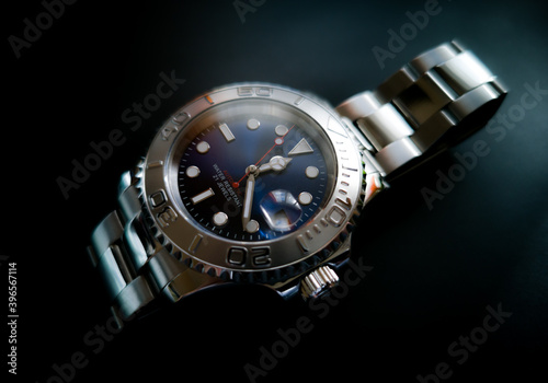 Stainless steel bracelet, unbranded diver watch with blue sunburst dial.