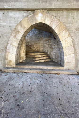 Stone Arch In Wall Over Stairs Leading Up