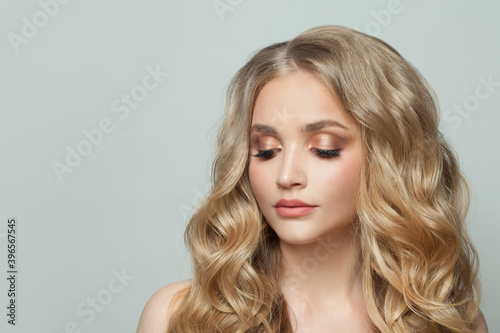 Pretty woman with natural makeup and curly hair portrait