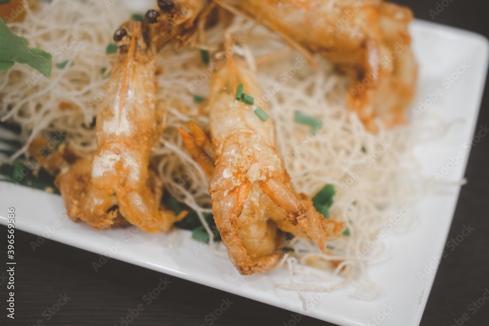Crispy fried prawn with garlic and pepper in white plate Crispy fried prawn with garlic and pepper in white plate