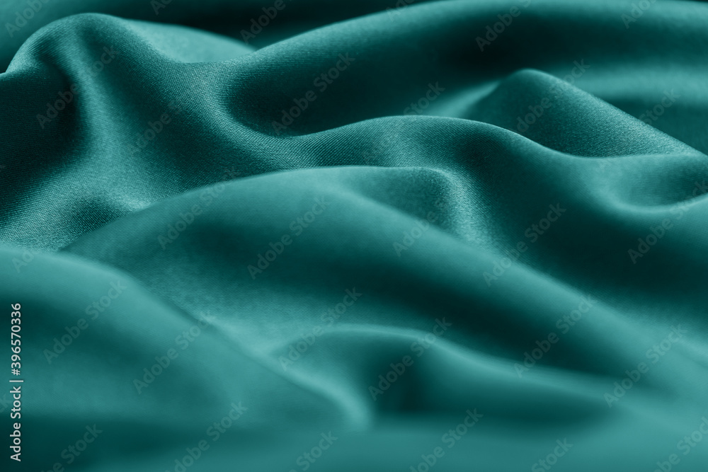 Obraz premium Creative background of green silk. Abstract texture.Tidewater green color of the year 2021.Selective focus with shallow depth of field,blurred foreground