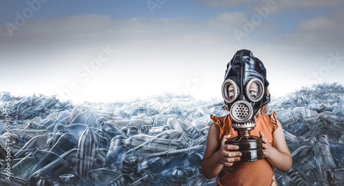 little caucasian girl with gas mask and mountains of empty plastic bottles behind her.