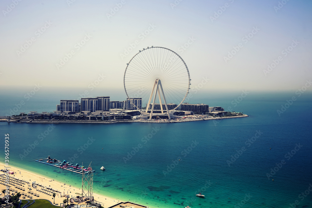 Dubai eye, UAE - 09.14.2020: Dubai ferris wheel on Bluewaters island during day with nine installed cabins and part of Jumeirah beach  