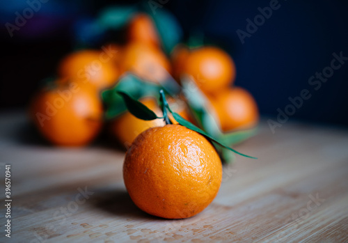 orange tangerines with leaves on a beige background, new year mood, Christmas, new year