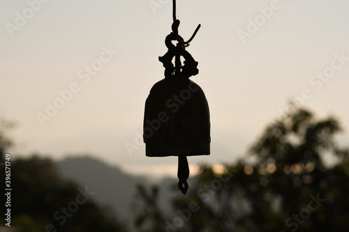 Small brass bells hanging on temple roof