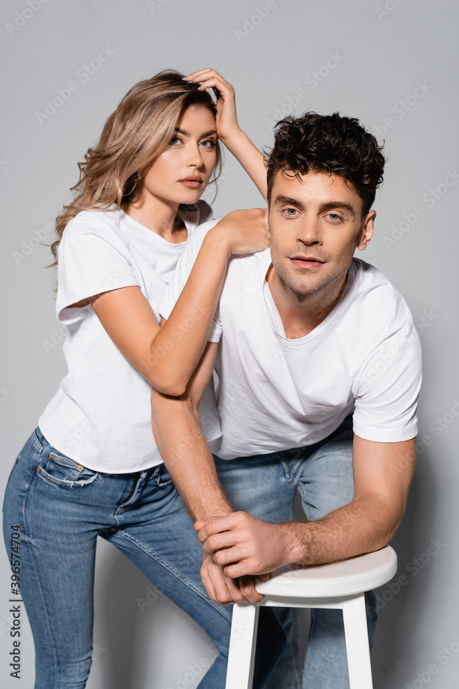couple in white t-shirts hugging isolated on grey couple in white t-shirts hugging isolated on grey