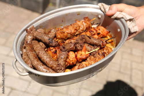 Braai meat inside an aluminium container. South African food. This photo has selective focus. 