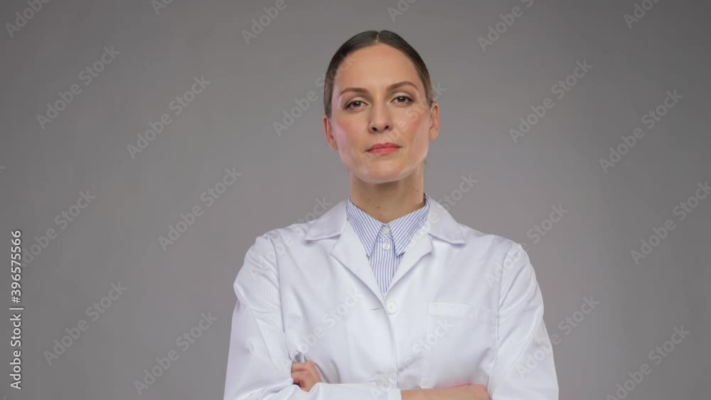 medicine, profession and healthcare concept - portrait of female doctor in white coat having video call or online consultation over grey background medicine, profession and healthcare concept - portrait of female doctor in white coat having video call or online consultation over grey background