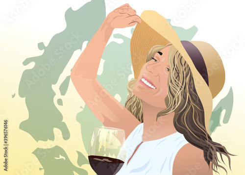 Joyful blonde woman in sunhat and white blouse with a glass of wine in her ha...