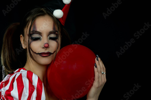 Fun photo session with a young arlekin woman dressed in red, black and white. Nice images for carnival days or for costume and makeup businesses.