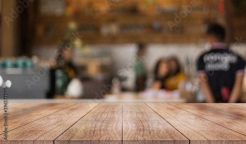 Empty wooden top table with blur coffee shop background.