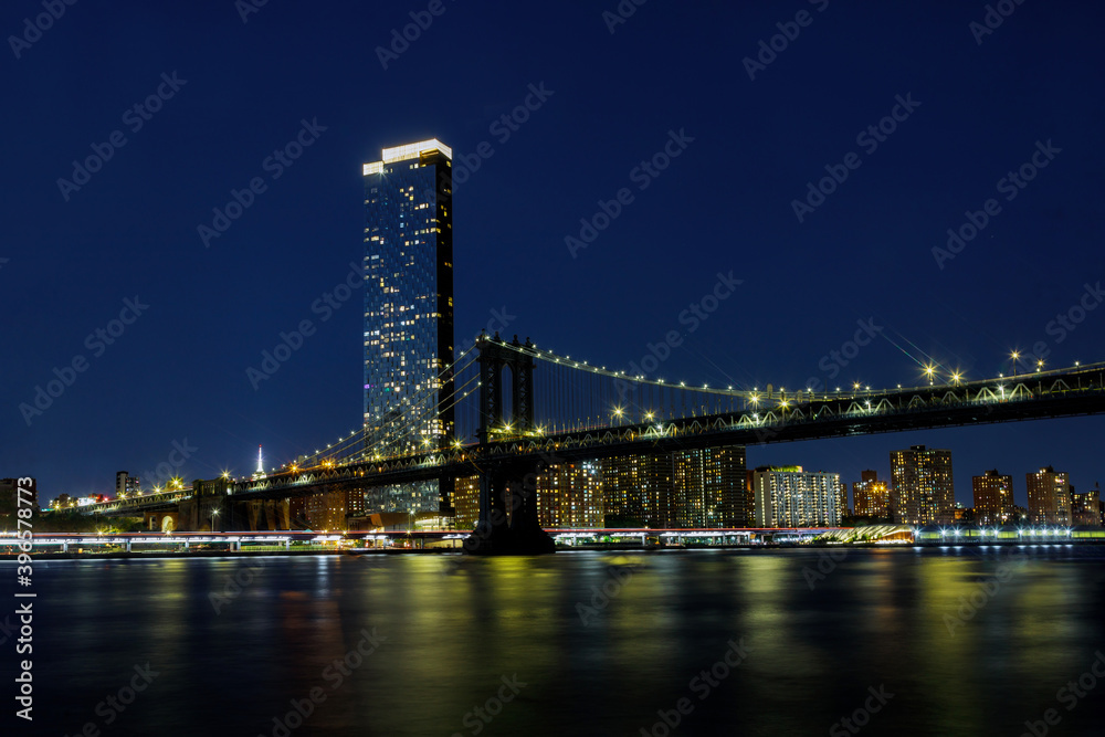 Manhattan Bridge with Brooklyn New York City skyscrapers city over Hudson River New York, night scene