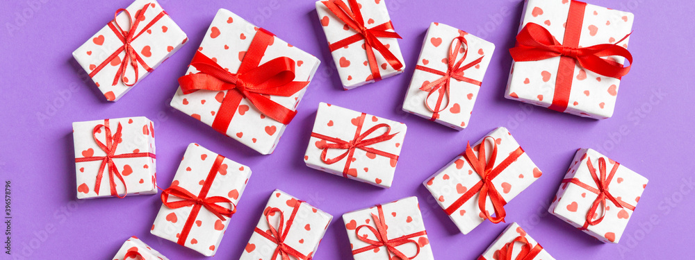 Top view of white gift boxes with hearts on colorful background. Valentine's Day concept Top view of white gift boxes with hearts on colorful background. Valentine's Day concept