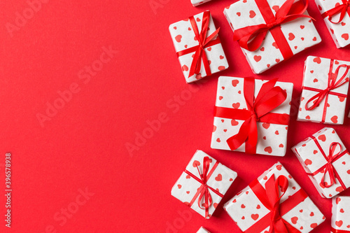 Top view colorful valentine background made of gift boxes with red hearts. Valentine's Day concept with copy space