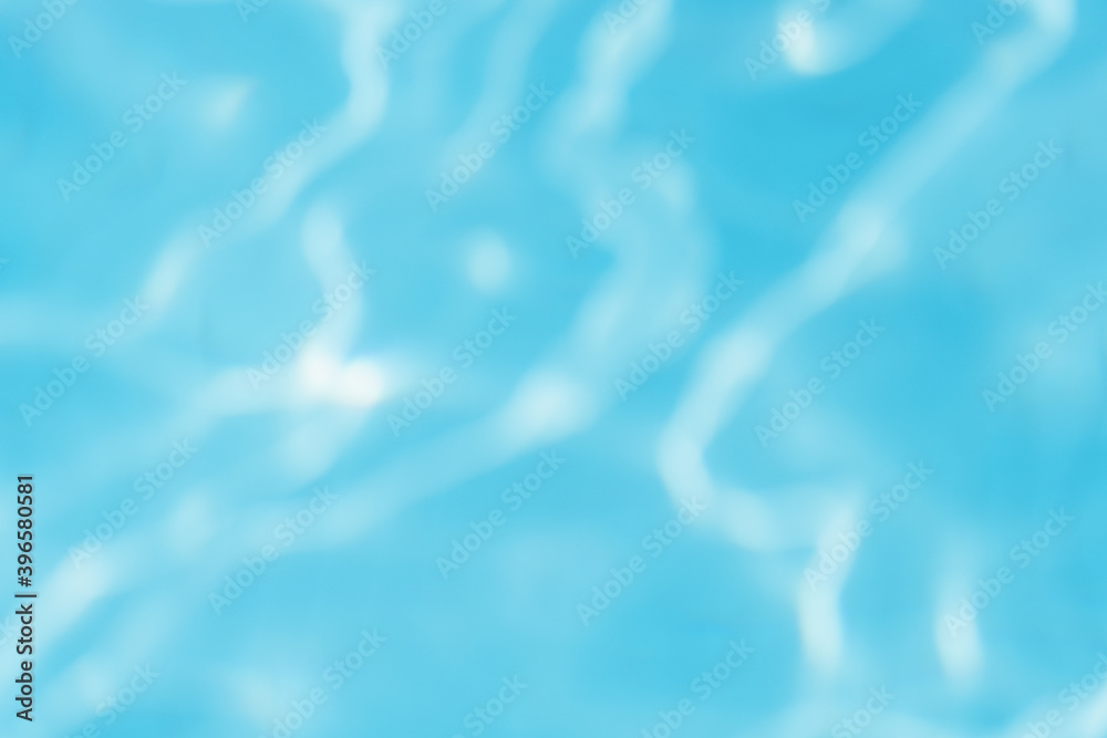 Beautiful abstract gradient photo background. Unfocused sunny rippling blue surface of outdoors swimming pool.