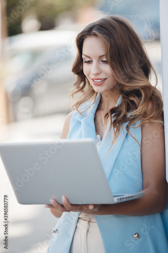 Portrait of a young woman with laptop outdoor Free Download Portrait of a young woman with laptop outdoor - GFXLoad