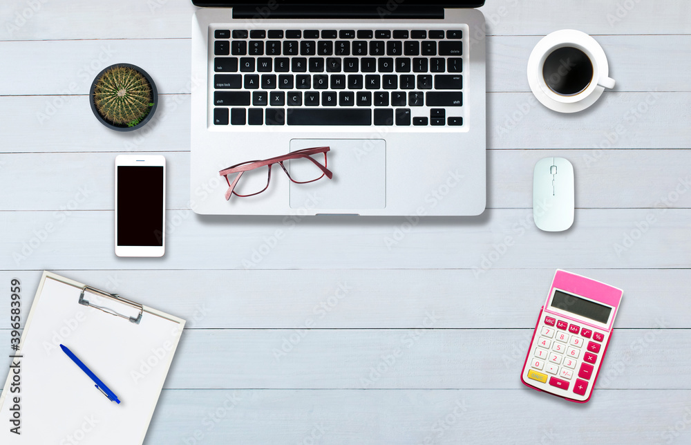 Fototapeta premium Top view above the computer notebook on the office-style white wood floor.