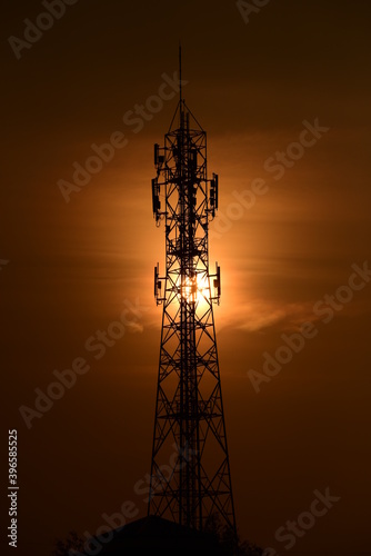 Telecommunication tower Antenna and satellite dish at sunset sky backgroundommunication tower Antenna and satellite dish at sunset sky background