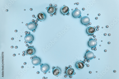 Christmas decorations on blue background. Round frame for text. Flat lay, top view, copy space