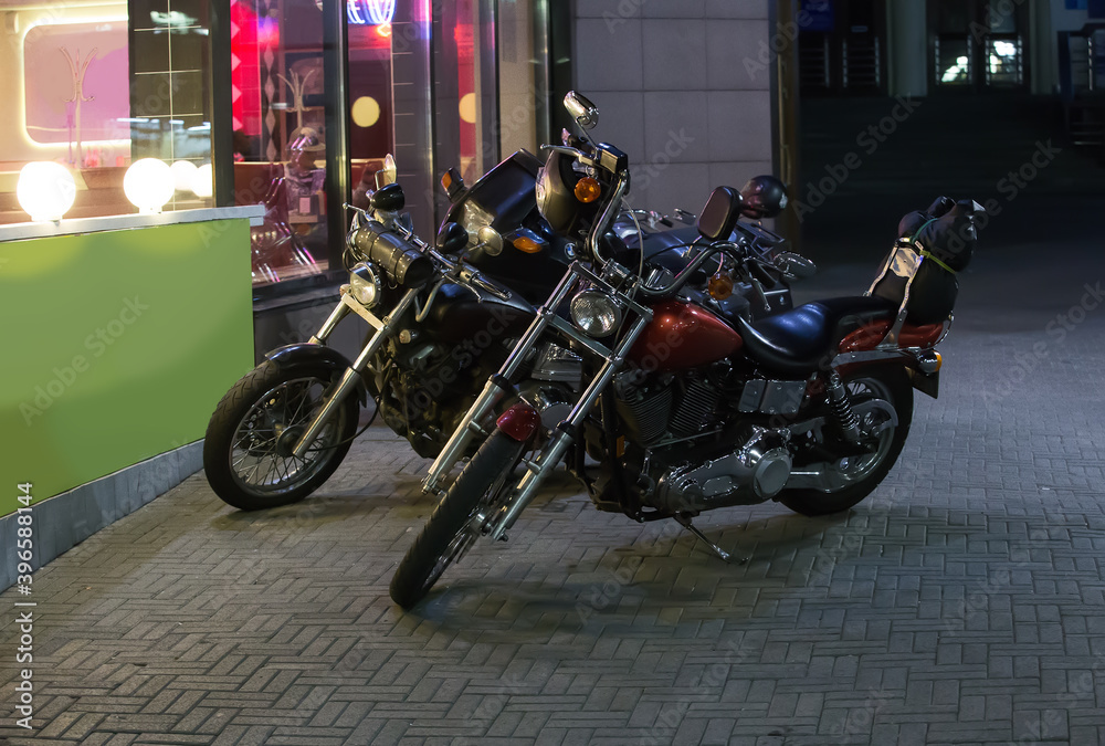 Motorcycles at night by the bar
