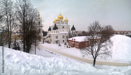 Photo shot of a Large snow hill, a hill, Huge snowdrifts along the paths against the background of an Orthodox Church.