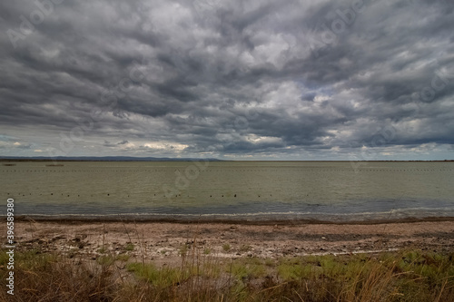 A landscape of the saltwater Pomorie lake with a stormy sky. Bulgaria © Petia