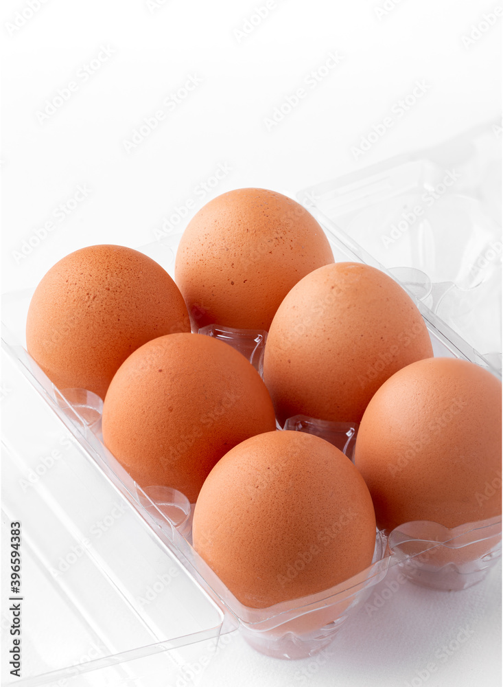 Half dozen of extra large brown eggs in a clear plastic carton with copy space Half dozen of extra large brown eggs in a clear plastic carton with copy space