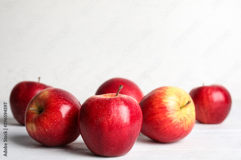 Ripe red apples on white wooden table. Space for text Ripe red apples on white wooden table. Space for text