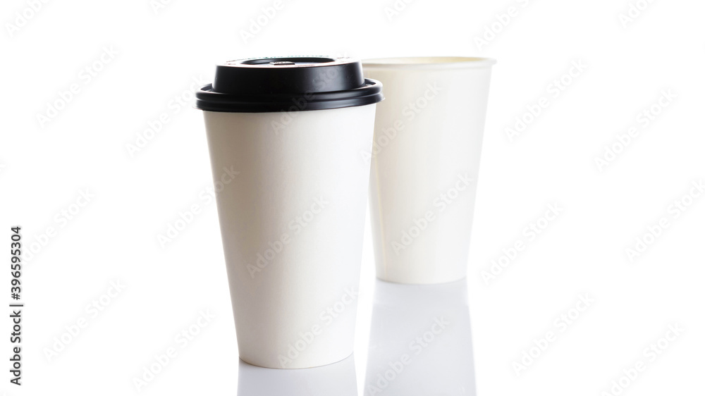 White paper cup for hot coffee with black lid isolated on white background. Takeaway blank small tea cup for your design text or banner of brand. White paper cup for hot coffee with black lid isolated on white background. Takeaway blank small tea cup for your design text or banner of brand.