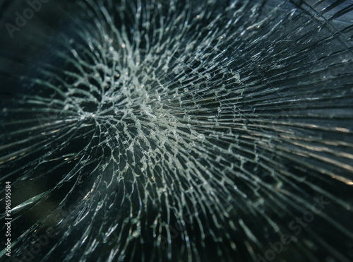 Cracks in the broken windshield of car