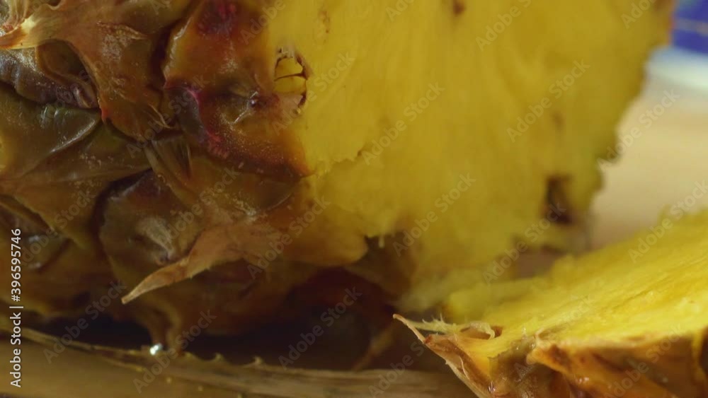 Close-up of freshly cut pineapple, tilt up