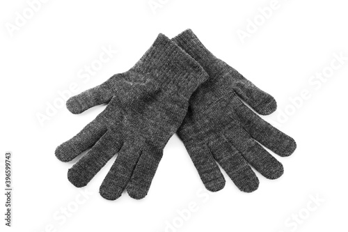 Grey woolen gloves on white background, top view. Winter clothes