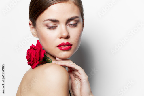 Attractive woman naked shoulders Red lips clean skin flower rose 