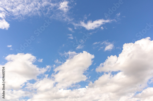 Beautiful blue clear sky with white clouds background in sunny day and copy space. Nature bright sky background image. Summer blue sky. Texture for Design. Natural cloudy Wallpaper.