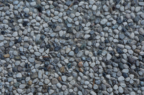 Seamless structure of white, grey and black stones or street gravel, crushed stones, stones background with space for text