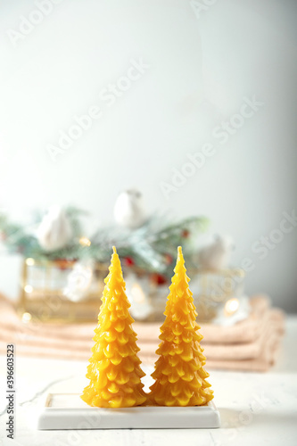 wax candles in the New Year's interior, on a light background, home comfort