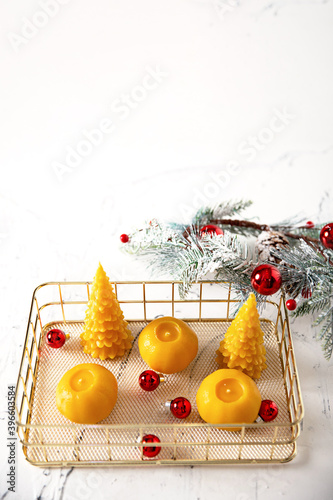 wax candles in the New Year's interior, on a light background, home comfort